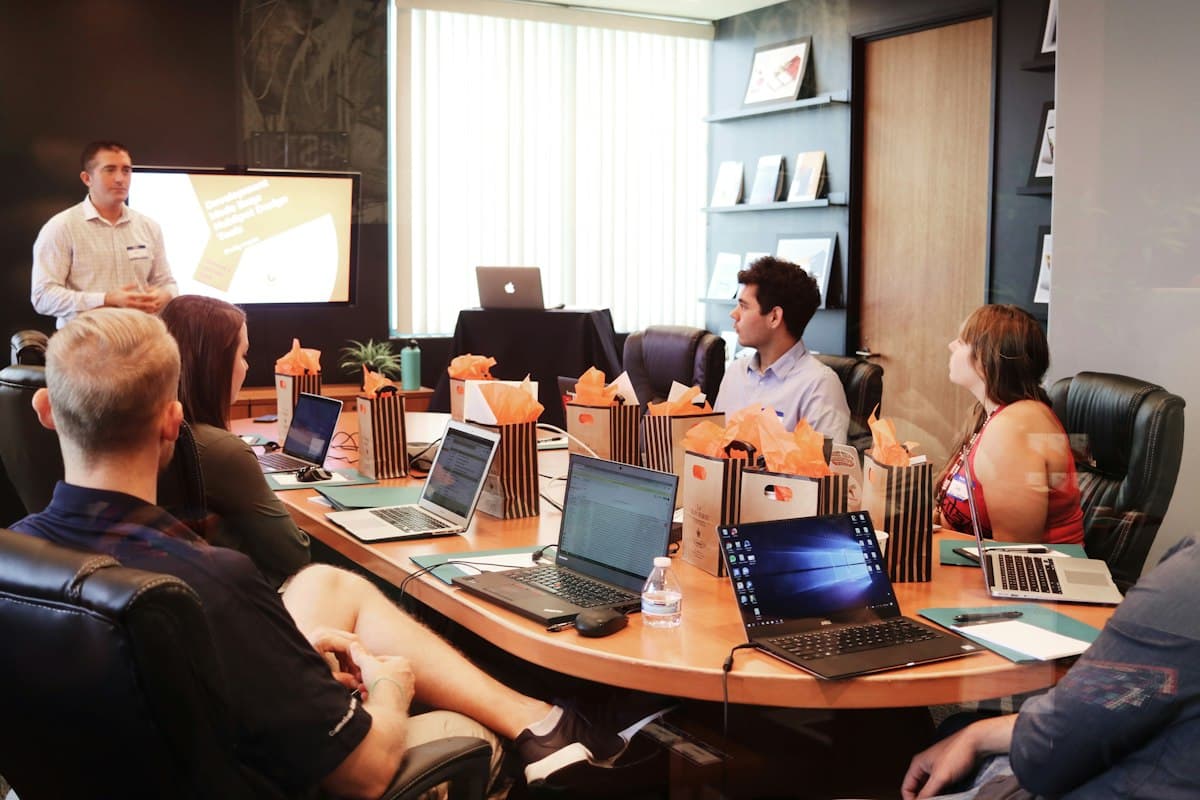 Presenter leading a planning meeting with a team around a conference table